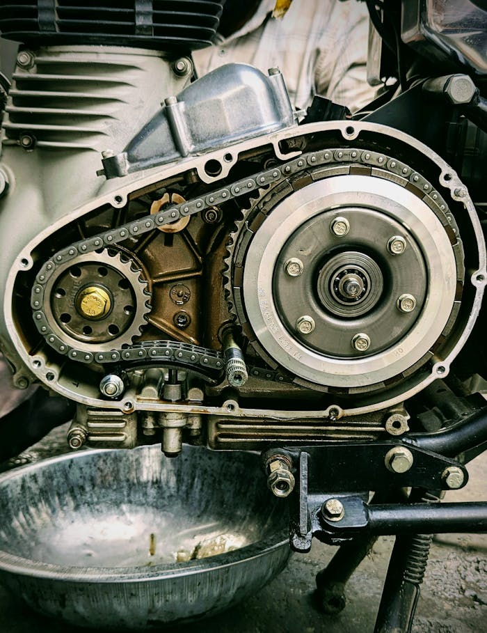 Detailed view of motorcycle engine internals with chain and gears in focus. Ideal for mechanical themes.